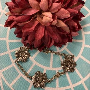 Vintage silver-toned chain designer bracelet with three flowers.